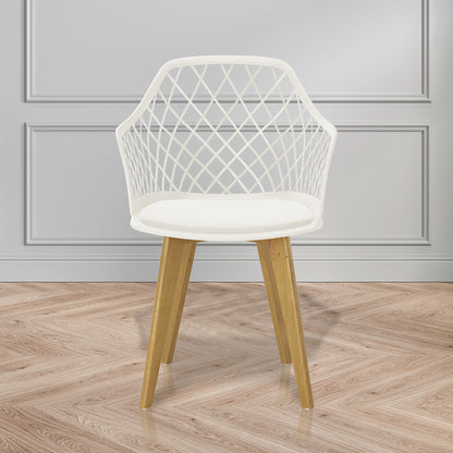 Caesar Beech Dining Chair Set of 4 in Cream White, featuring a white lattice-patterned plastic shell, smooth seat cushion, and angled wooden legs, displayed against a pale gray paneled wall on a herringbone floor.