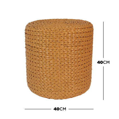 Carla 40cm Water Hyacinth Pouffe Ottoman - Honey, a small, cylindrical woven stool made of braided natural fibers, ideal for use as a footrest, extra seat, or decorative accent.