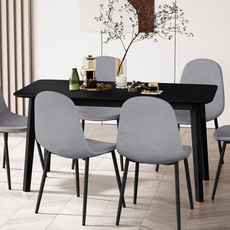 Connie 150cm 4 Seater Hardwood Dining Table in Black, featuring a matte-black rectangular tabletop with sturdy legs, surrounded by six light-gray upholstered chairs on a herringbone floor, showcasing a modern dining setup.