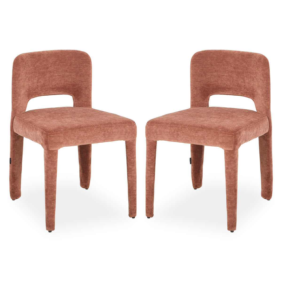 Two terracotta upholstered dining chairs with curved backs, cut-out detail and tapered legs