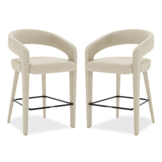 Eisha Velvet Bar Stool Beige Set of 2 features sleek white chairs with black legs, armrests, and a built-in footrest, offering elegant style and comfort for dining or bar areas.