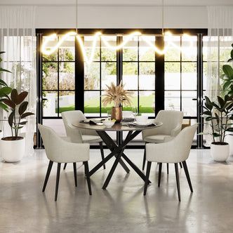 Ella Linen Dining Chair Set of 2 in Cream White, featuring light-gray upholstery, black metal legs, and a contemporary design, placed around a round dining table in a bright, modern dining area.