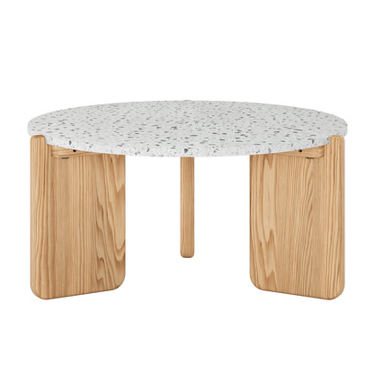 Everlee Hardwood American Oak Coffee Table in Natural features a white terrazzo top with gray flecks, supported by three light-wood legs, including two wide flat panels and a central cylindrical post.