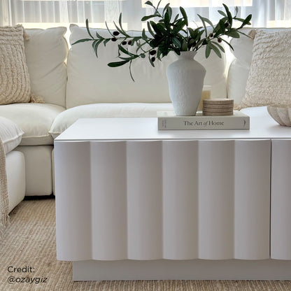 Close-up of the Hamish 120cm Coffee Table with Storage, showcasing its sleek wave design and spacious top surface, ideal for decor. Visible drawers highlight the table's practical storage feature.