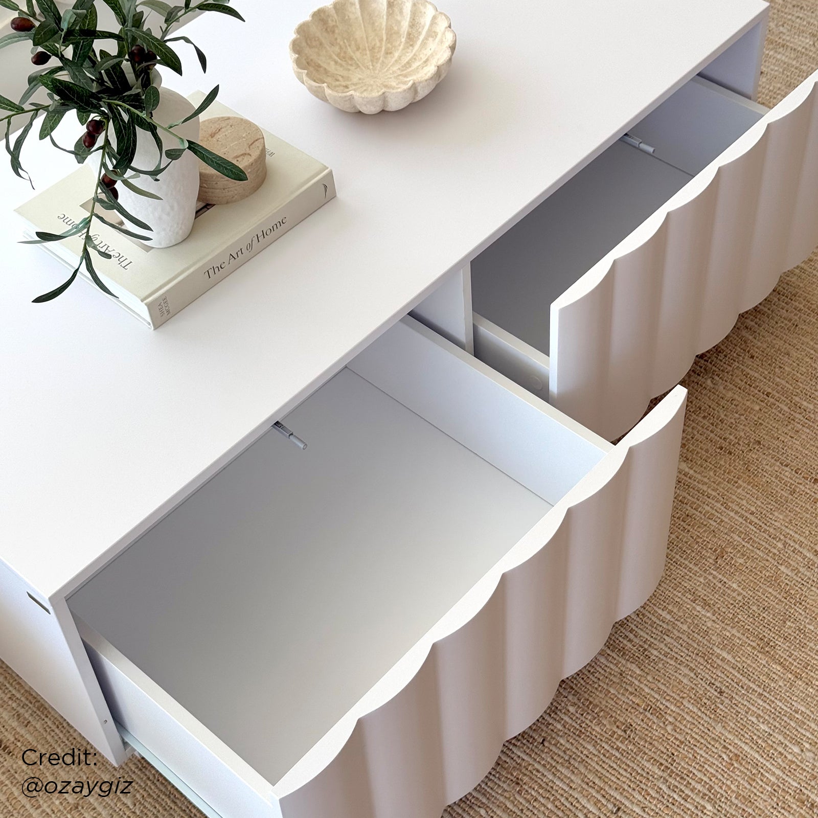 Close-up of the Hamish 120cm Coffee Table with Storage, showcasing its sleek wave design and spacious top, with two soft-close drawers, embodying modern style and functionality for a living room setting.