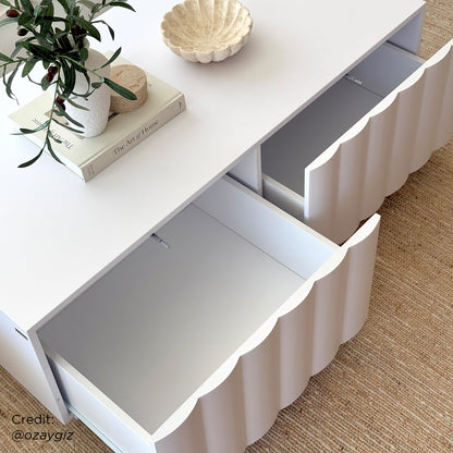 Close-up of the Hamish 120cm Coffee Table with Storage, showcasing its sleek wave design and spacious top, with two soft-close drawers, embodying modern style and functionality for a living room setting.