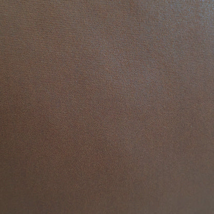 Close-up of smooth mocha brown fabric upholstery featuring a fine, uniform matte texture.