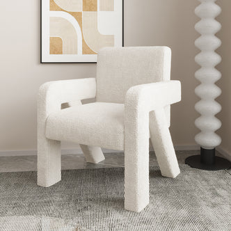Julie Boucle Upholstered Accent Chair Cream White in a room, showcasing its soft boucle fabric and modern design. Positioned in front of a painting, highlighting its plush seat and sturdy engineered wood structure.