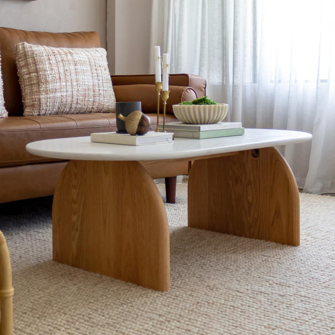 Kerry 120cm Solid Oak Oval Coffee Table - White Natural, featuring a sleek oval top and sturdy natural oak legs, perfectly complements a modern living room setting with its stylish and durable design.