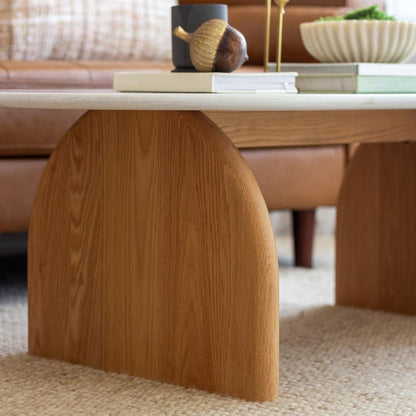 Close-up of the Kerry 120cm Solid Oak Oval Coffee Table featuring a white tabletop and sturdy natural oak legs, highlighting its modern design and durable construction for a stylish living room centerpiece.