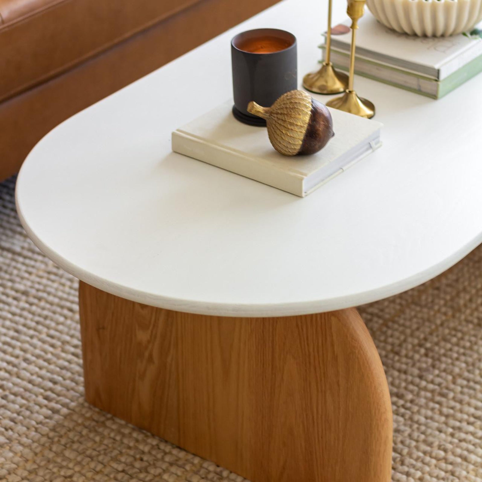 Kerry 120cm Solid Oak Oval Coffee Table - White Natural featuring a sleek white top and sturdy natural oak legs, set on an indoor coffee setting.