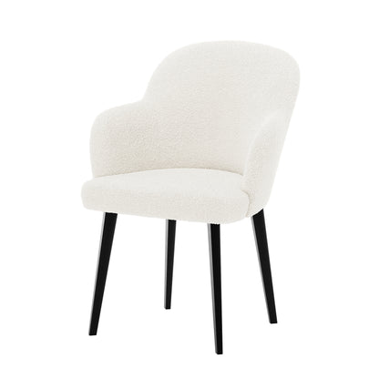 Lennon Bouclé Dining Chair Set of 2 in Cream White features a modern, curved back with integrated armrests, upholstered in textured bouclé fabric, supported by slim, tapered black legs.