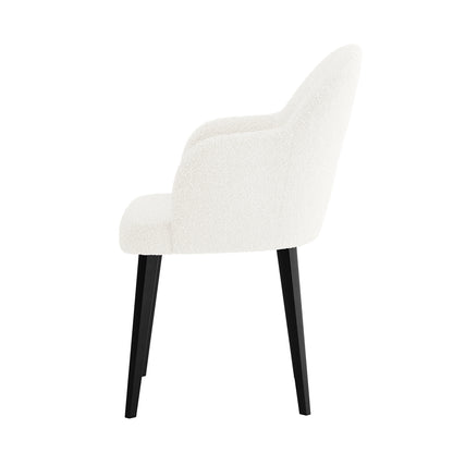 Lennon Bouclé Dining Chair Set of 2 in Cream White features modern upholstered chairs with curved backs, integrated armrests, and black tapered legs, offering elegant style and plush comfort for any dining space.