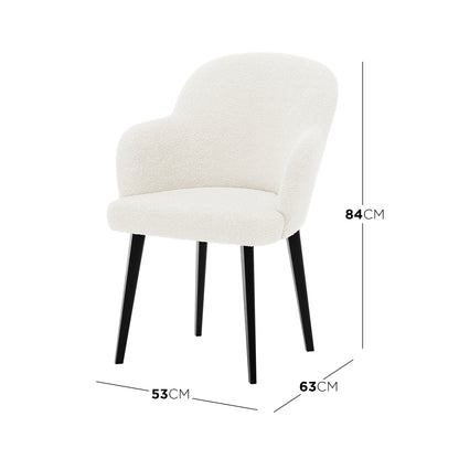 Lennon Bouclé Dining Chair Set of 2 in Cream White features a modern upholstered design with a curved back, integrated armrests, and slim black legs, highlighted by its dimensions and ergonomic comfort.