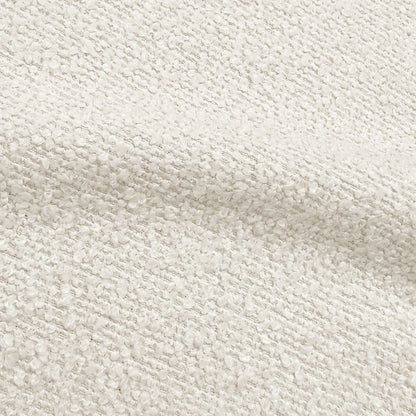 Close-up of textured cream bouclé upholstery fabric showing the soft, looped weave.   