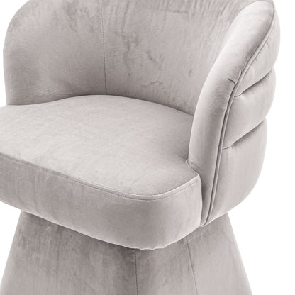 Close-up of the grey swivel dining chair highlighting its cushioned seat and supportive channeled backrest.   