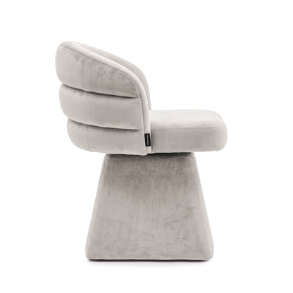 Side profile of the grey swivel dining chair showing its tiered channel-back and pedestal base.   