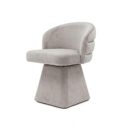Grey swivel dining chair with a curved channeled back and chunky square pedestal base.   