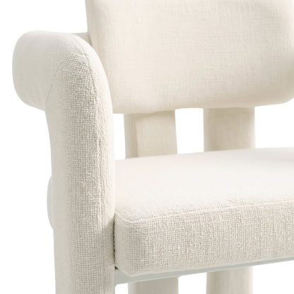 Partial view of an off-white upholstered chair on a white background