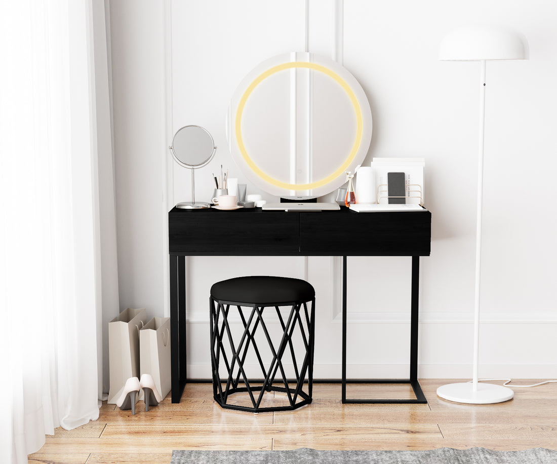 Ophira Dressing Table with Touch Screen Mirror Light – Black features a slim black table with two drawers, a glowing round LED mirror, and a geometric stool in a minimalist setting.
