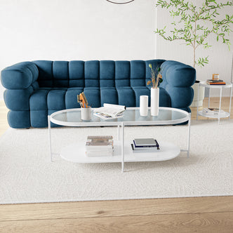 Rebecca Fluted Glass Coffee Table Set White showcasing a stylish design with fluted glass tops on a sturdy metal frame, placed indoors on a round table amidst magazines and books, reflecting modern interior aesthetics.