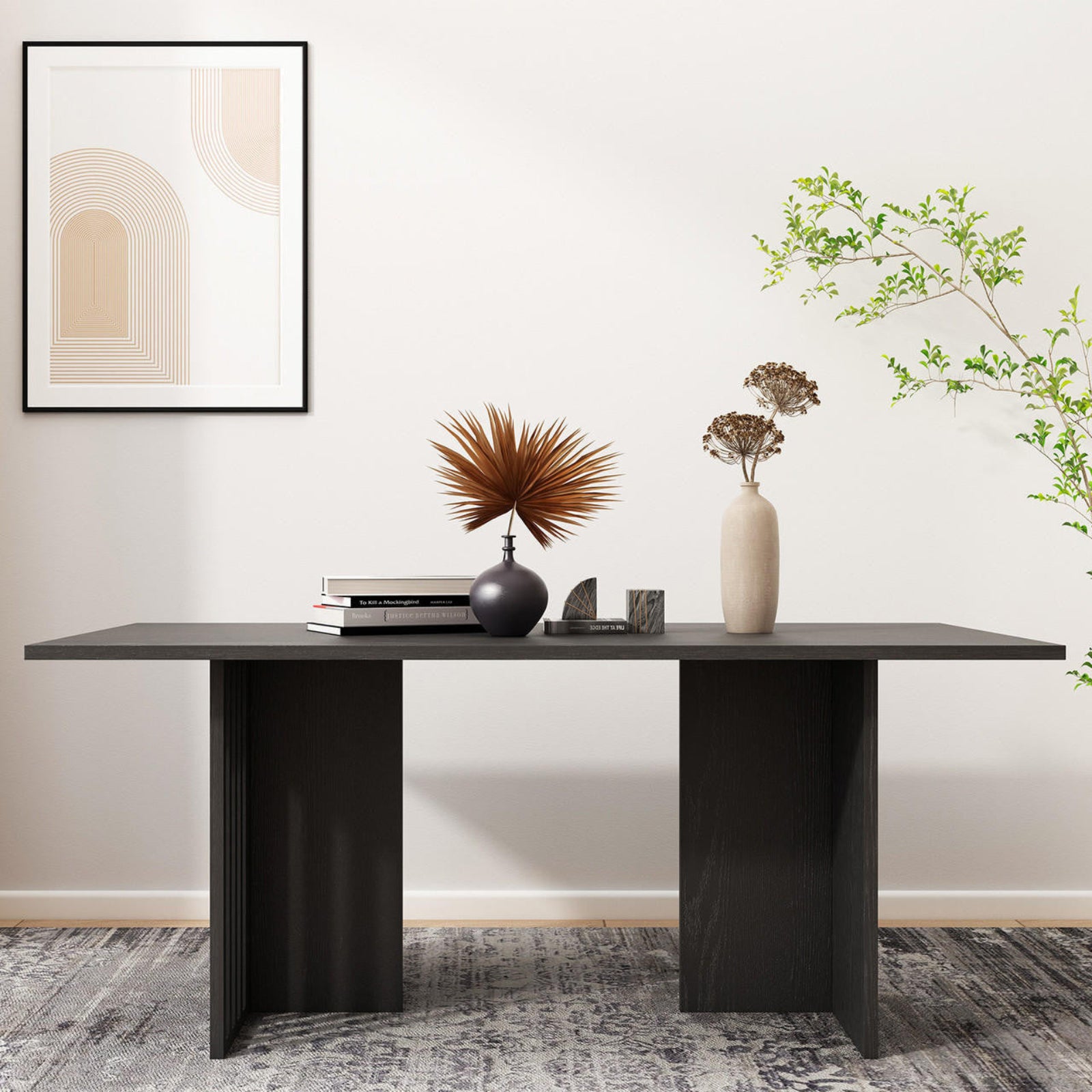 Rowley 180cm Dining Table Black, showcased with a dark-stained wood finish, features alongside decorative vases, books, and abstract art, highlighting its modern aesthetic and functional elegance.