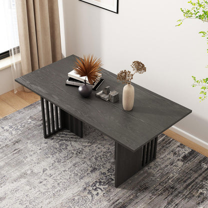 Rowley 180cm Dining Table Black on patterned rug with decorative vases, books, and marble-look blocks. Features a sleek, modern design ideal for stylish dining and gatherings.