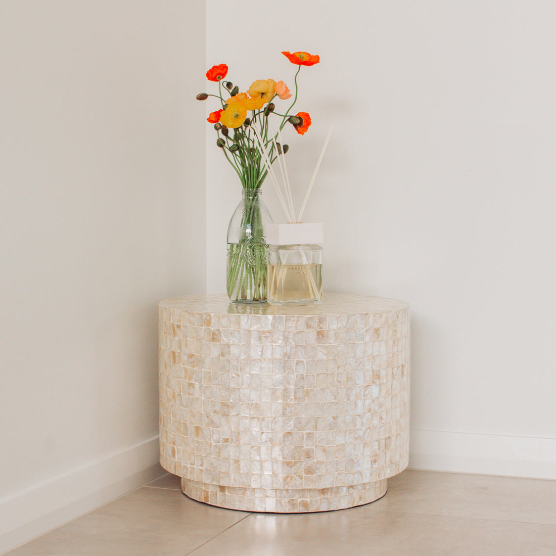 Tiffany 48cm Mother of Pearl Inlay Side Table Cream with intricate floral design, showcasing hand-crafted mother-of-pearl mosaic inlay, elegantly displayed in an indoor setting with a vase of flowers.