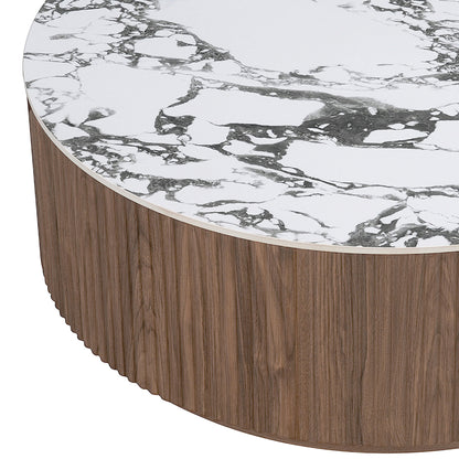 Round sintered stone coffee table with white and grey marble-look top and fluted walnut wood veneer base, close-up detail