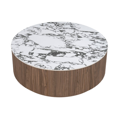Round sintered stone coffee table with white and grey marble-look top and fluted walnut base on white background