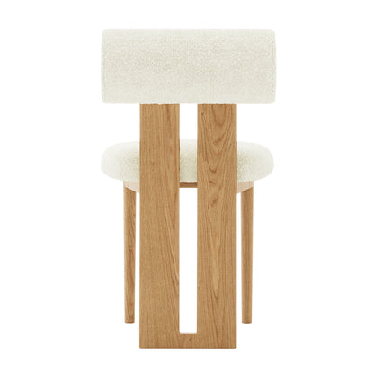 Wylie Boucle Oak Dining Chair Cream White Set of Two showcasing plush boucle upholstery, thick cushioning, and elegant American oak-paneled legs, emphasizing comfort and sophisticated design in a close-up view.
