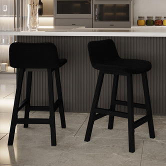 Yael Boucle Upholstered High-Back Bar Stool Black Set of 2, featuring sleek high backs and boucle upholstery, positioned next to a counter in a modern kitchen setting.