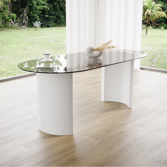 Zora 200cm Round Tempered Glass Oval Dining Table featuring a sleek glass top and stylish engineered wood legs, positioned elegantly on a glass surface, enhancing any modern dining space.