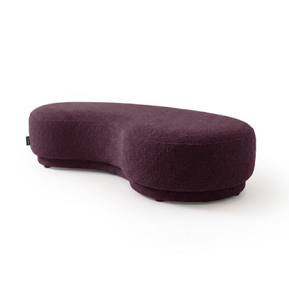 Kidney-shaped plum upholstered bench  seat on a white background