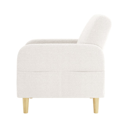 Anica Single Seater Bouclé Sofa Chair in Cream White with a rounded barrel silhouette, plush bouclé upholstery, and light wooden legs, showcased from the side on a white background.