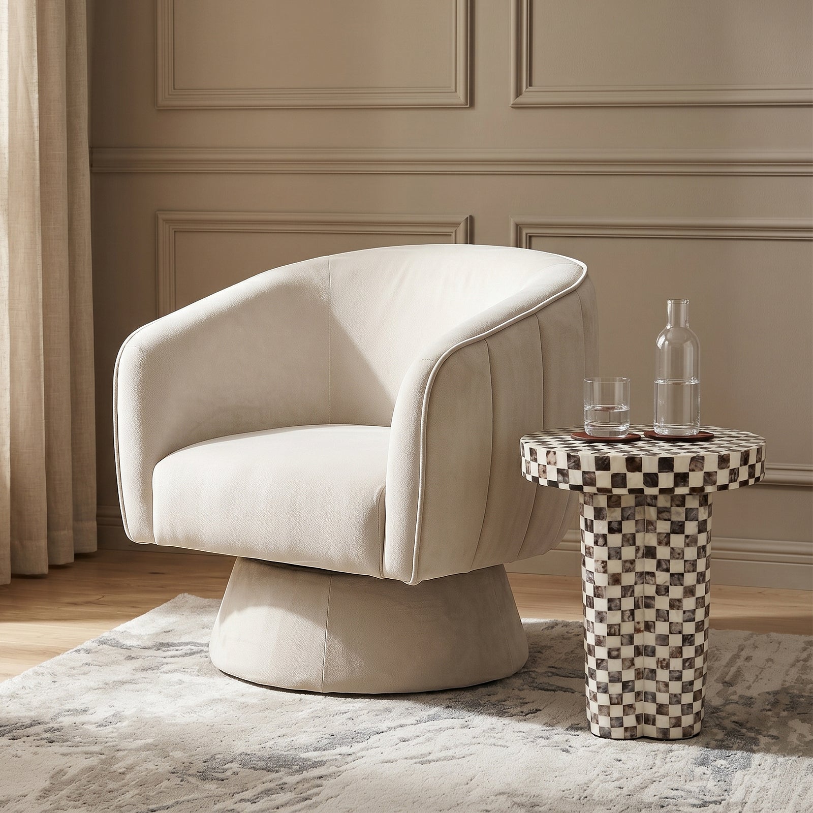 Arlo Chenille 360° Swivel Accent Chair in Oatmeal, featuring a rounded design and light cream upholstery, sits invitingly in a softly-lit lounge, embodying comfort and sleek modernity.