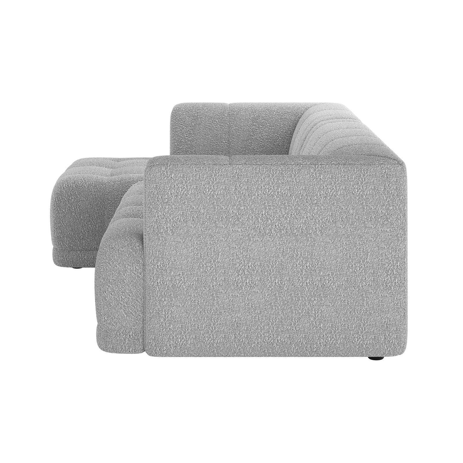 Averill 4 Seater Bouclé Fabric Chaise Sofa in Grey, featuring a light grey textured fabric, modular L-shaped design with low blocky arms, deep tufted cushions, and an integrated chaise section.