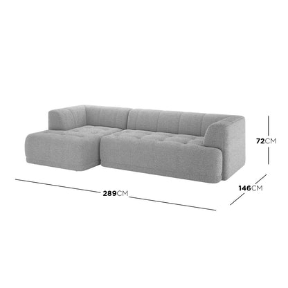 Averill 4 Seater Bouclé Fabric Chaise Sofa in Grey, showcasing a modern L-shape, light-grey textured fabric, channel-tufted backrest, and seat cushions, with a left-side chaise lounge for versatile seating.