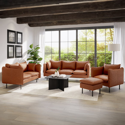 Cassian 7 Seater PU Leather Sofa Set in Mocha features a 3-seater, 2-seater, armchair, and ottoman, all in cognac-brown leather, complementing a cozy, contemporary living room with black wood coffee table.