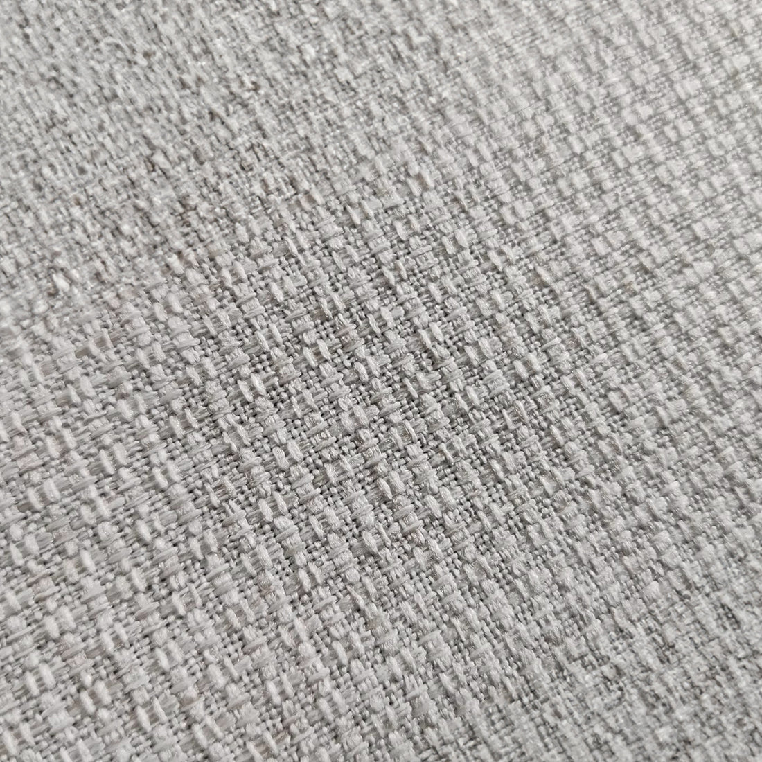 Close-up of the Celeste 3 Seater Hardwood Fabric Sofa, showcasing its textured fabric surface and sturdy frame, highlighting its blend of style and durability.