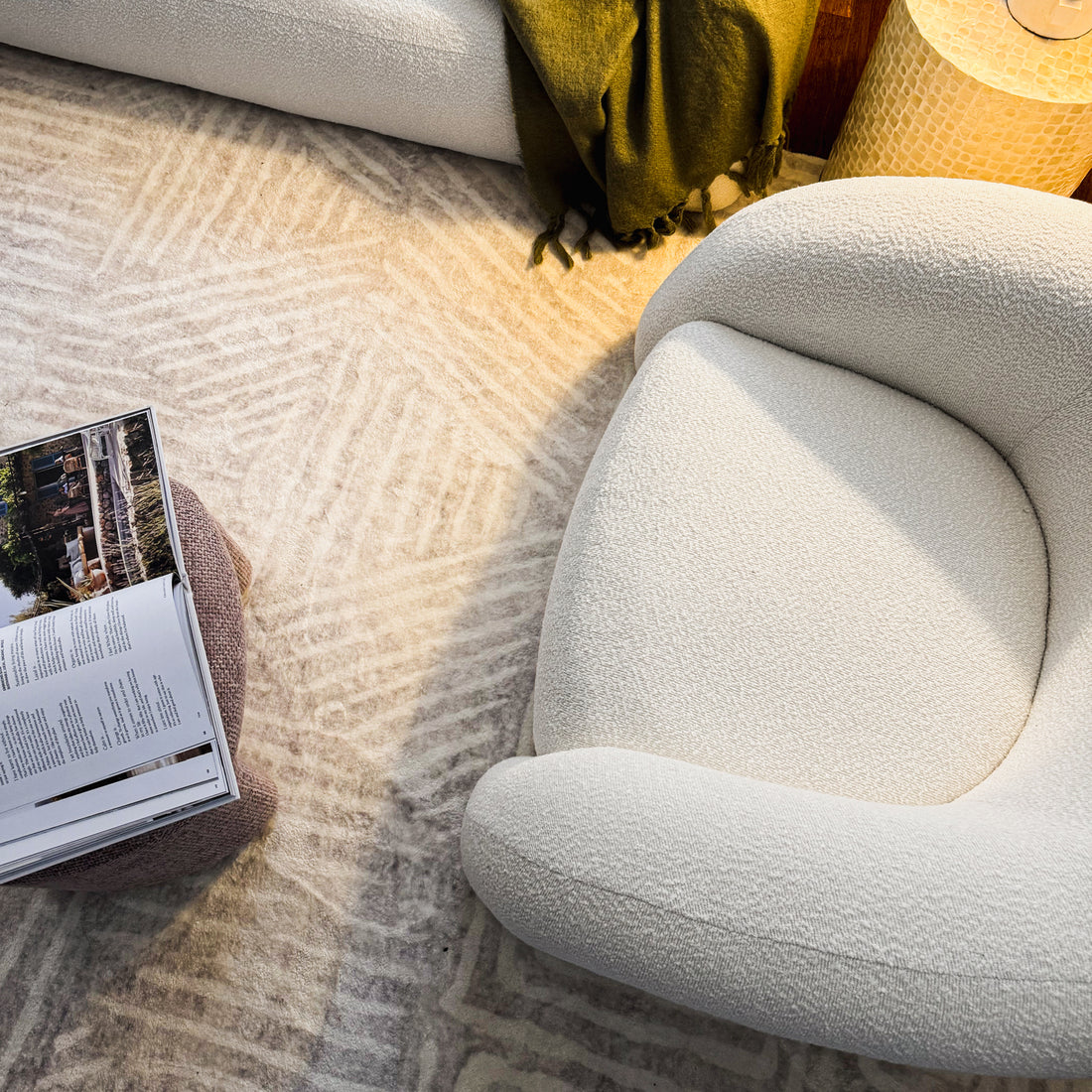 Clioz Bouclé Fabric Accent Armchair in eggshell white, showcasing its luxurious boucle texture and solid wood frame, positioned in a modern living room setting with a mid-century design aesthetic.