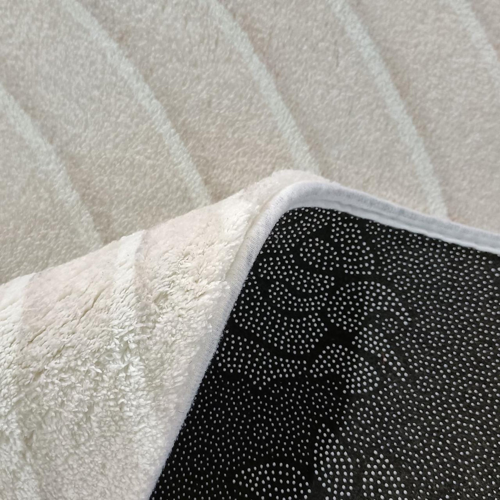 Close-up of Colton Living Room Package in Cream White, showcasing a plush bath-style rug's texture and non-slip backing, highlighting the set's emphasis on comfort and modern design.
