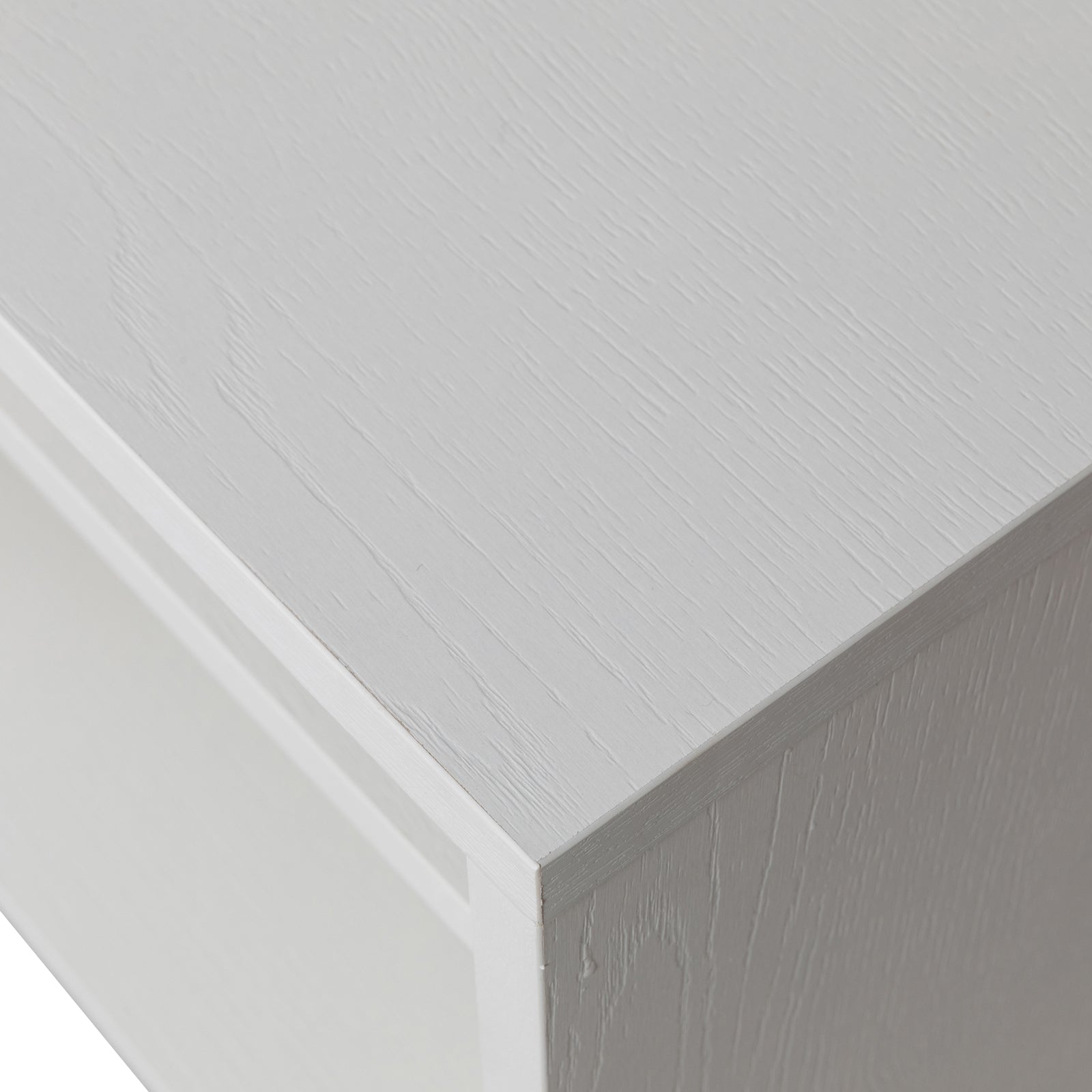 Close-up of white wood-grain textured corner from the Colton Living Room Package in Cream White, highlighting the right-angled join between panels with a matte finish, emphasizing the contemporary design.
