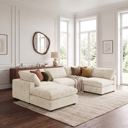 Light beige sectional sofa with ottoman in a bright living room