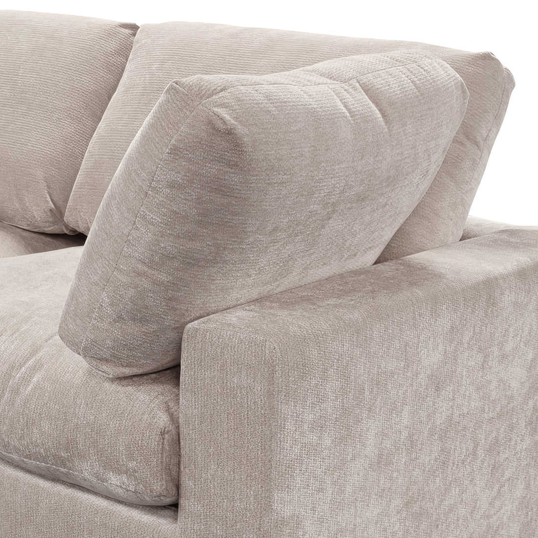 A close-up, angled view of the corner section of a light taupe modular sofa, highlighting its plush, textured fabric and deep, supportive cushioning.
