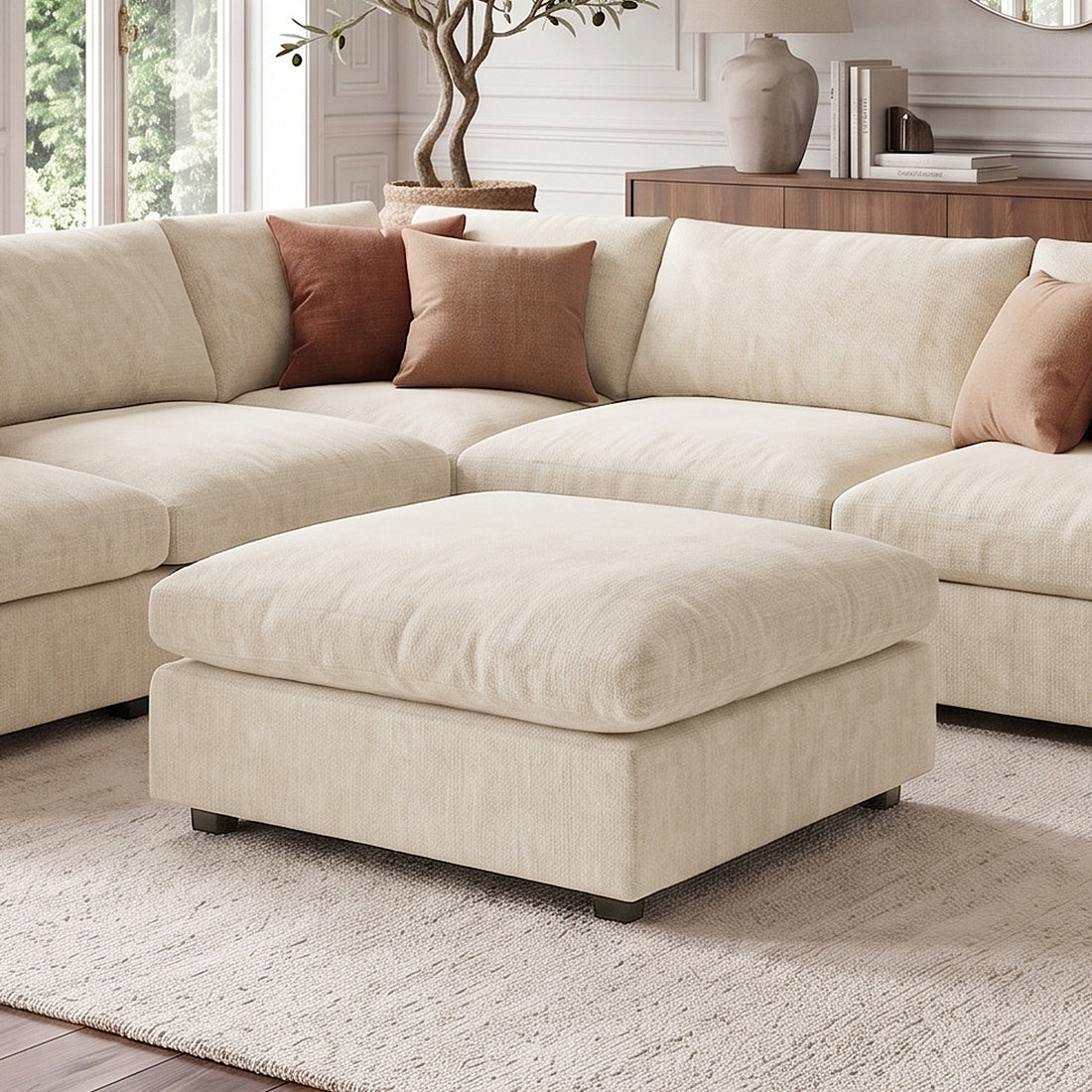 Light beige sectional sofa with ottoman styled in a living room