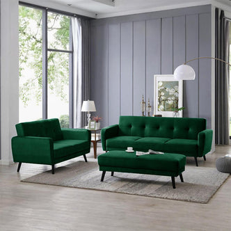 Esben Velvet Fabric Ottoman in Forest Green sits centrally on a light rug, featuring a cushioned seat with Scandinavian-style wooden legs, complementing the matching loveseat and tufted sofa in the styled living room.