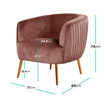 Evelyn Curved Velvet Sofa Accent Chair in Blush features a barrel-style design with channel-tufted back, blush velvet upholstery, and polished gold tapered legs, offering elegance and durability for modern interiors.