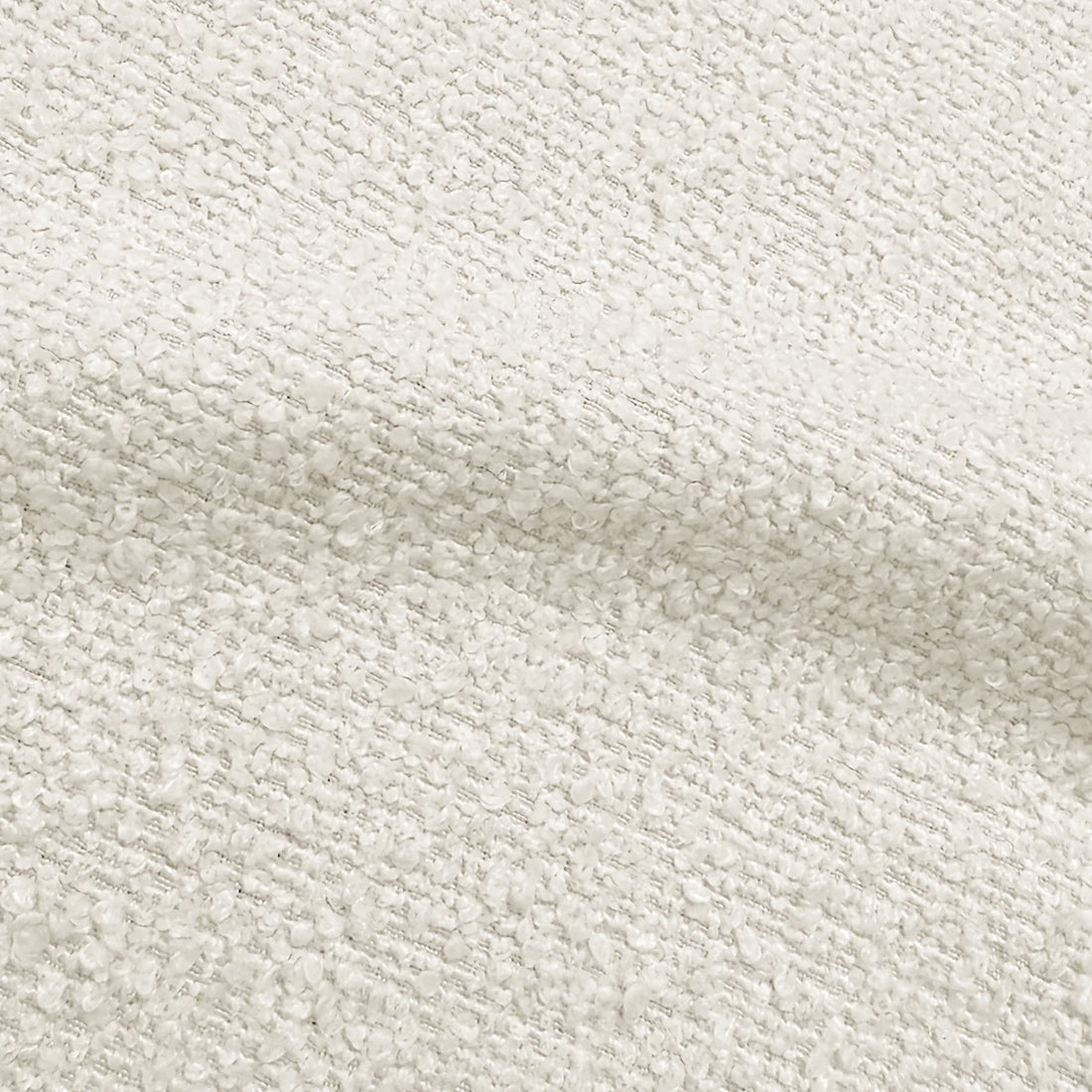 Close-up of textured cream bouclé upholstery fabric highlighting its soft, looped weave.   