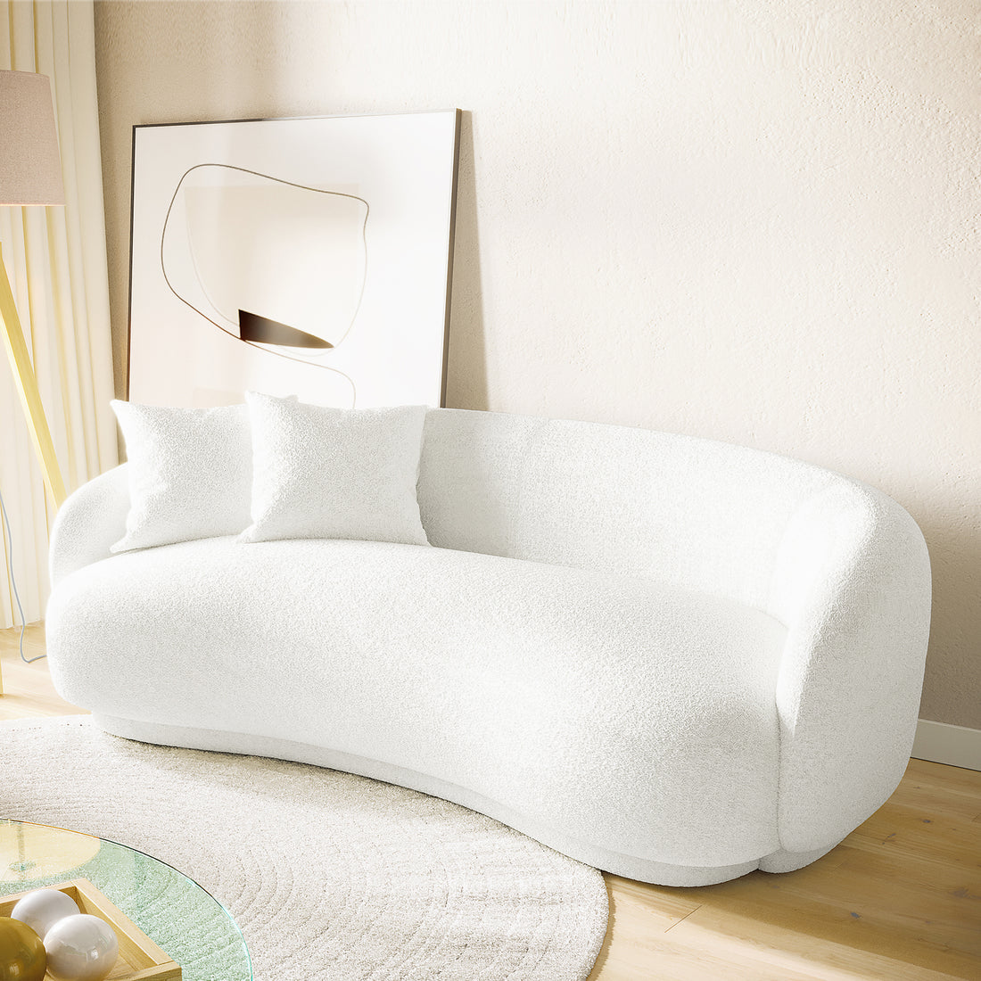 Janelle 191cm Boucle 3-Seater Curved Sofa in a modern room, showcasing its elegant curved design and plush bouclé texture, accompanied by two matching cushions for added comfort and style.